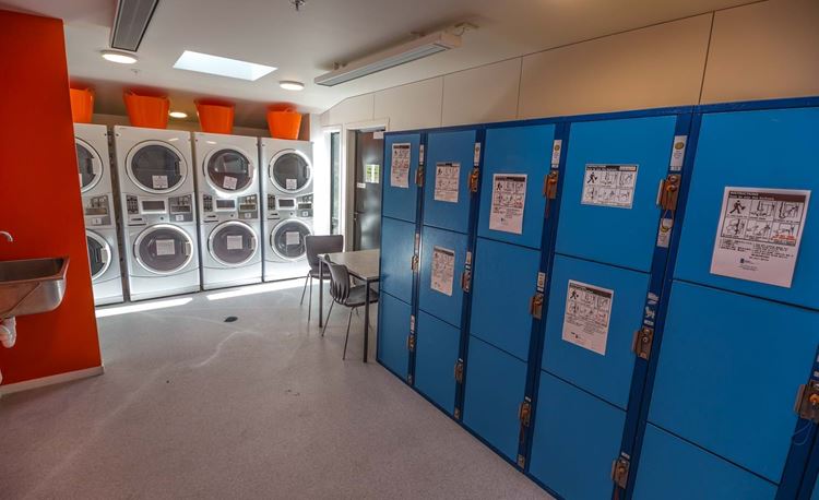 YHA Queenstown Lakefront self-service laundry room with paid storage lockers for accommodation guests