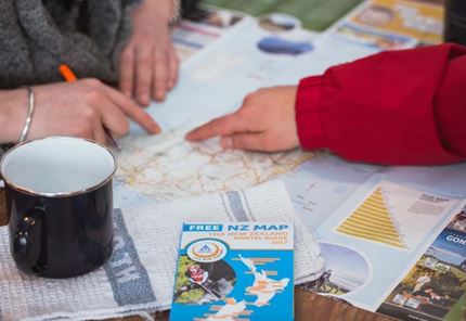 YHA Queenstown Lakefront backpackers planning New Zealand trip with map