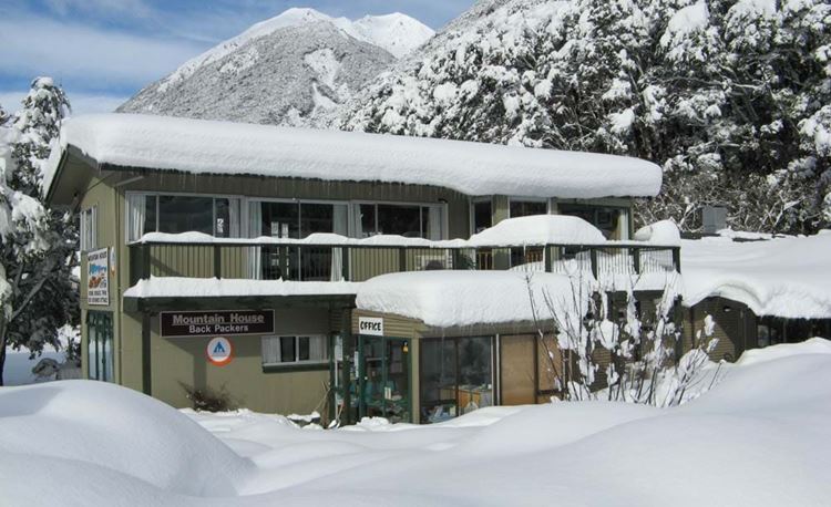 YHA Arthur's Pass front exterior of hostel covered in snow