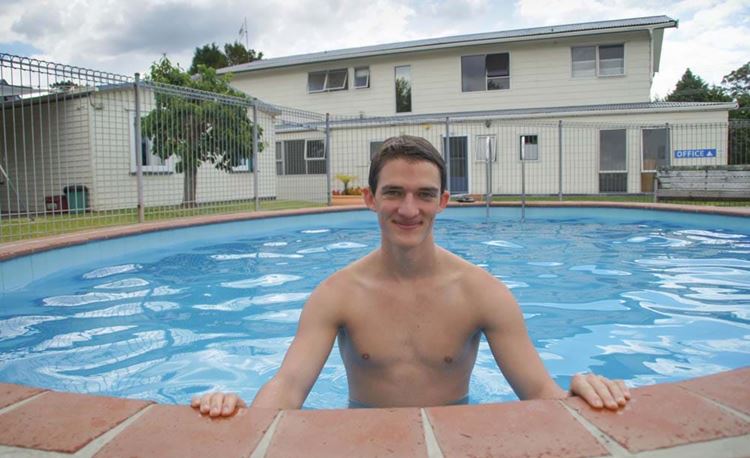 YHA Whangarei youth traveler taking a dip in the swimming pool