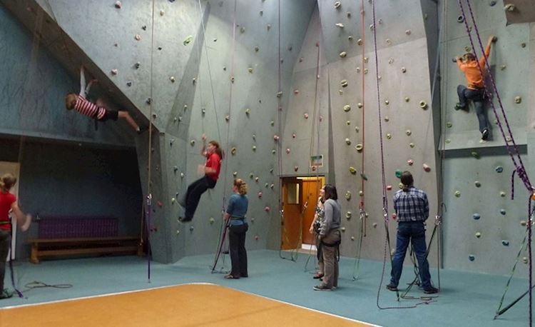 YHA National Park youth travelers scaling indoor climbing wall