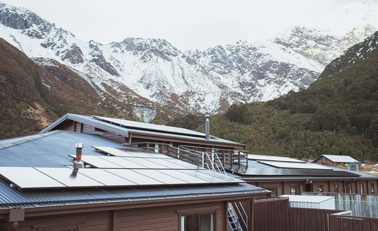 YHA mt cook aoraki solar panels on hostel roof with mountain backdrop