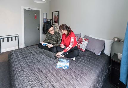 Two guests enjoy their stay at YHA Christchurch hostel
