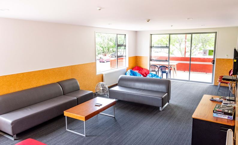 Lounge in YHA Rotorua's Group Accommdoation unit with views of Kuirau Park